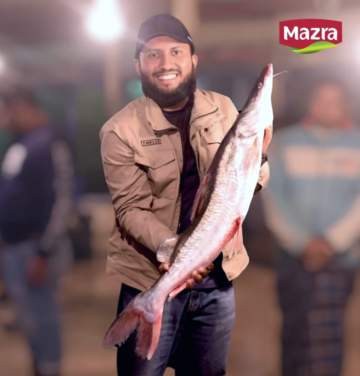 A man holding a big ayre fish in bangladeshi market